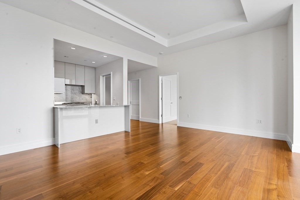 Empty room, Interior, Kitchen, Recessed Lighting, Stainless Steel Appliances, Wood Texture Flooring