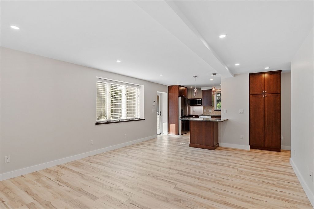 Empty room, Interior, Kitchen, Recessed Lighting, Stainless Steel Appliances, Wood Texture Flooring