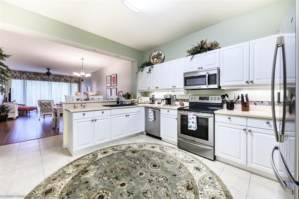 Chandelier, Dining room, Interior, Kitchen, Living room, Stainless Steel Appliances, Wood Texture Flooring