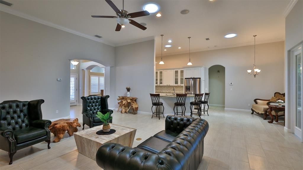 Chandelier, Dining room, Interior, Kitchen, Living room, Pendant Lights, Recessed Lighting, Stainless Steel Appliances, Wood Texture Flooring