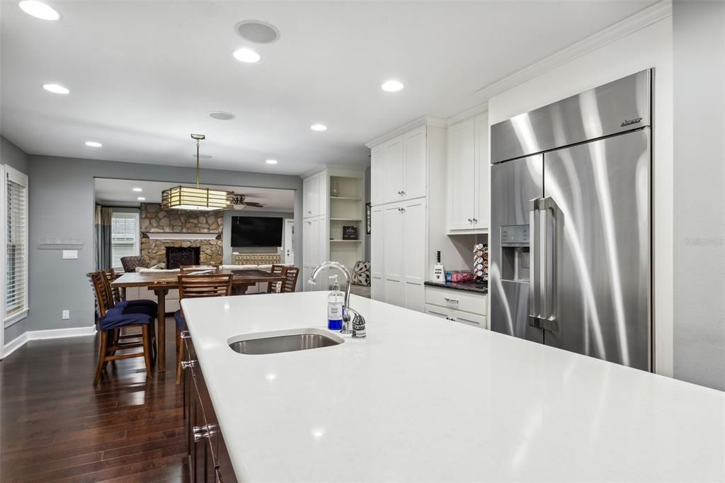 Dining room, Fireplace, Interior, Kitchen, Pendant Lights, Recessed Lighting, Stainless Steel Appliances, Stone Walls, Wood Texture Flooring