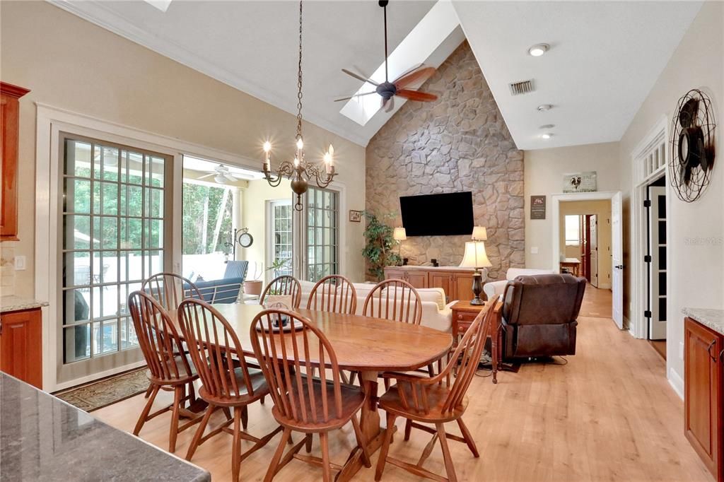 Chandelier, Dining room, Interior, Living room, Recessed Lighting, Stone Walls, Wood Texture Flooring