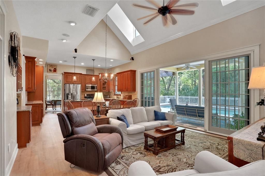 Chandelier, Dining room, Interior, Kitchen, Living room, Pendant Lights, Recessed Lighting, Stainless Steel Appliances, Wood Texture Flooring