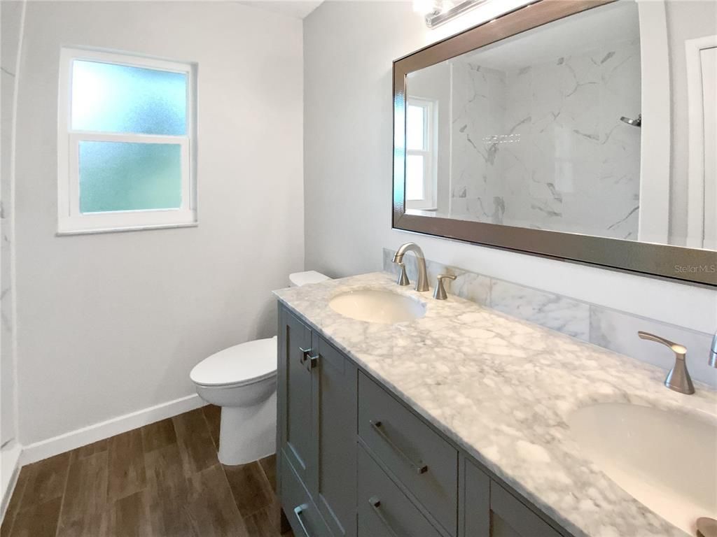 Bathroom, Dual Sink Vanities, Interior, Marble Walls, Wood Texture Flooring