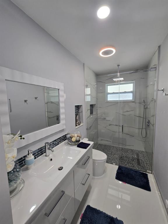 Bathroom, Dual Sink Vanities, Glass Shower, Interior, Marble Walls, Recessed Lighting