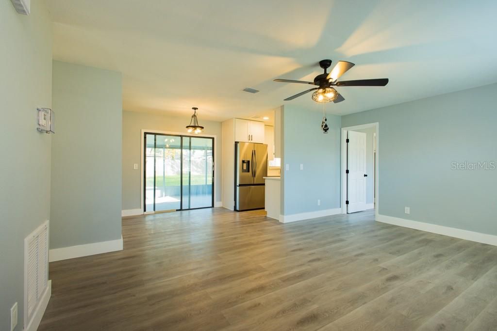Empty room, Interior, Kitchen, Pendant Lights, Stainless Steel Appliances, Wood Texture Flooring