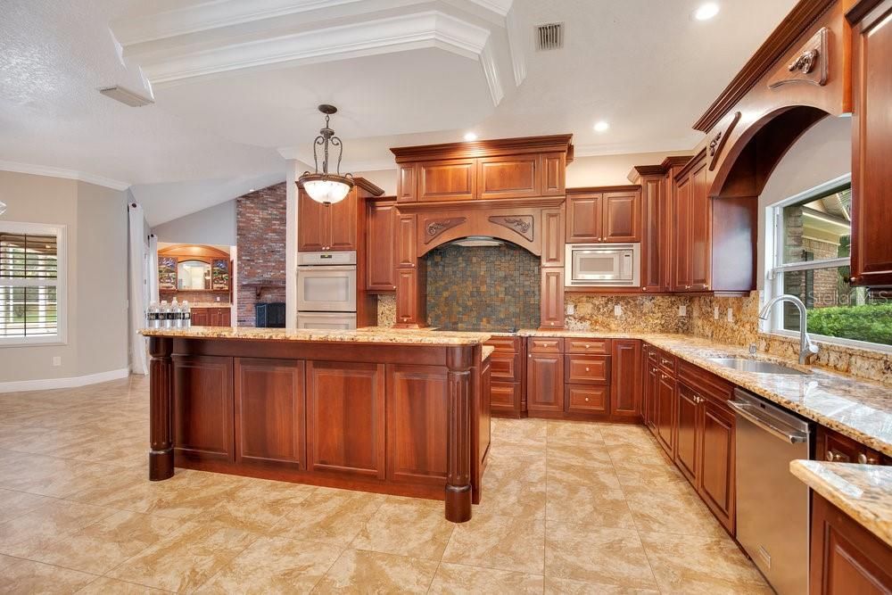 Fireplace, Interior, Kitchen, Pendant Lights, Recessed Lighting, Stainless Steel Appliances, Stone Walls