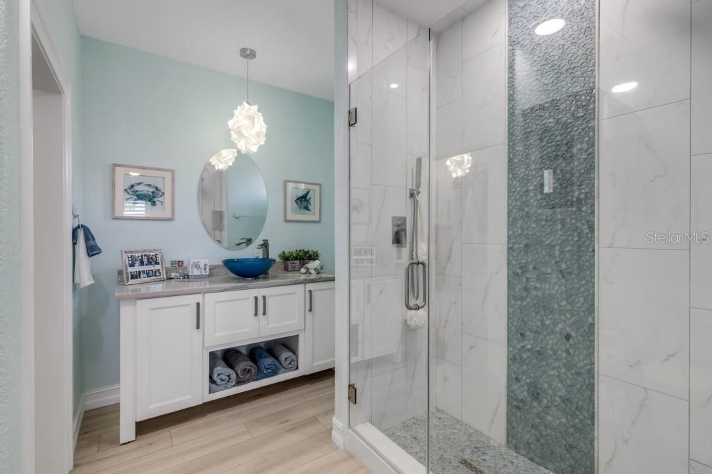 Bathroom, Glass Shower, Interior, Marble Walls, Pendant Lights, Recessed Lighting, Wood Texture Flooring