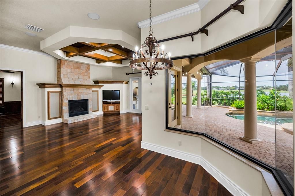 Chandelier, Fireplace, Interior, Pool, Stone Walls, Sun Room, Wood Texture Flooring