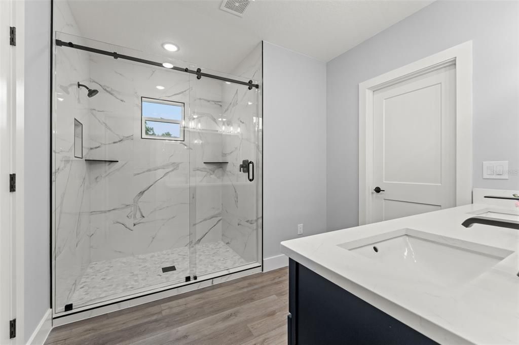 Bathroom, Glass Shower, Interior, Marble Walls, Recessed Lighting, Wood Texture Flooring