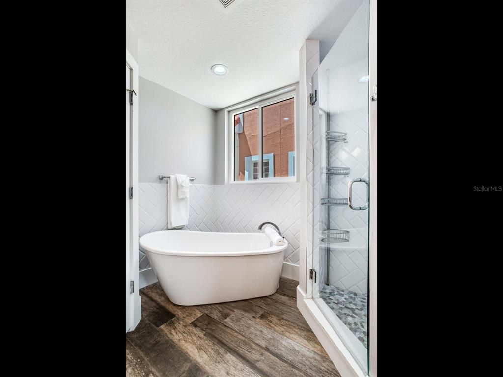Bathroom, Free Standing Baths, Glass Shower, Interior, Recessed Lighting, Wood Texture Flooring