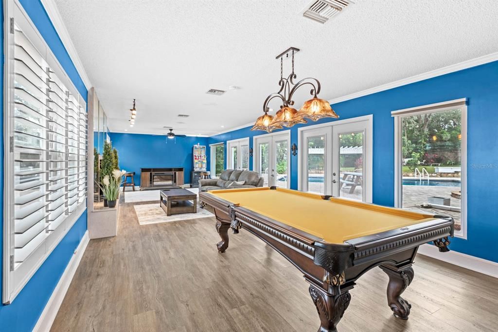 Billiard Table, Chandelier, Fireplace, Game Room, Interior, Living room, Wood Texture Flooring
