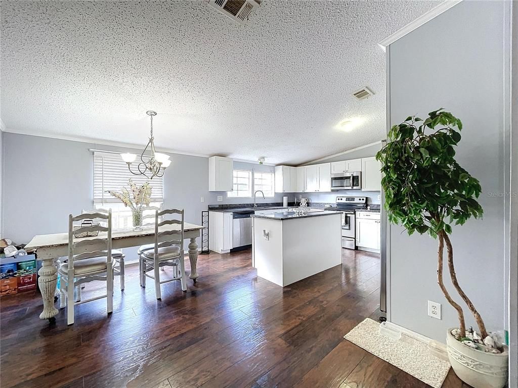 Chandelier, Dining room, Interior, Kitchen, Pendant Lights, Stainless Steel Appliances, Wood Texture Flooring