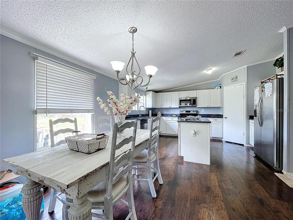 Chandelier, Dining room, Interior, Kitchen, Stainless Steel Appliances, Wood Texture Flooring