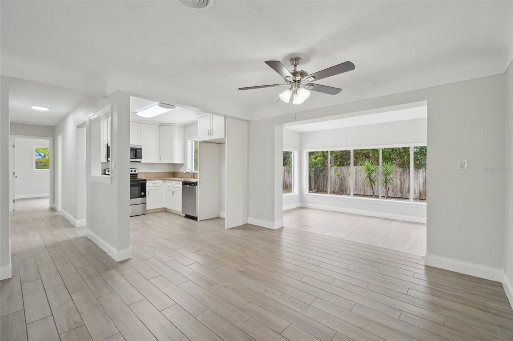 Empty room, Interior, Kitchen, Recessed Lighting, Stainless Steel Appliances, Wood Texture Flooring