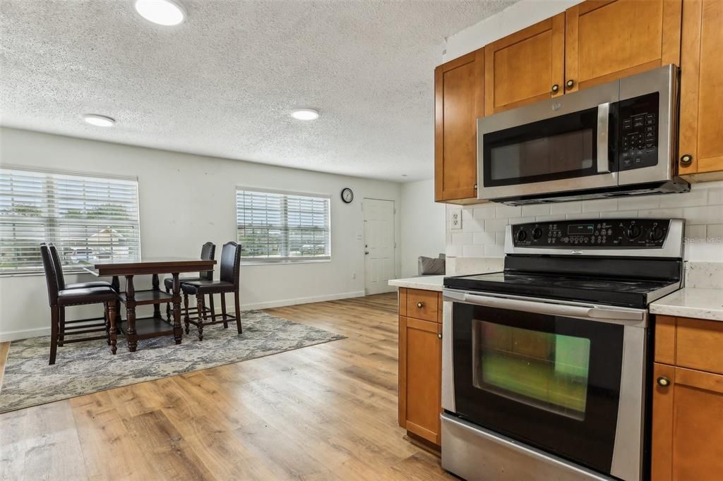 Dining room, Interior, Kitchen, Recessed Lighting, Stainless Steel Appliances, Wood Texture Flooring
