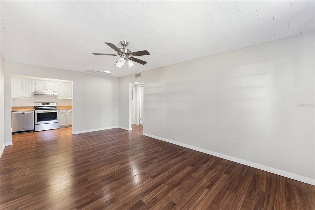 Empty room, Interior, Kitchen, Recessed Lighting, Stainless Steel Appliances, Wood Texture Flooring