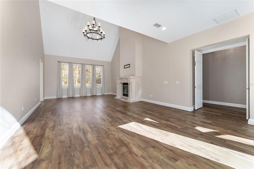 Chandelier, Empty room, Fireplace, Interior, Recessed Lighting, Wood Texture Flooring