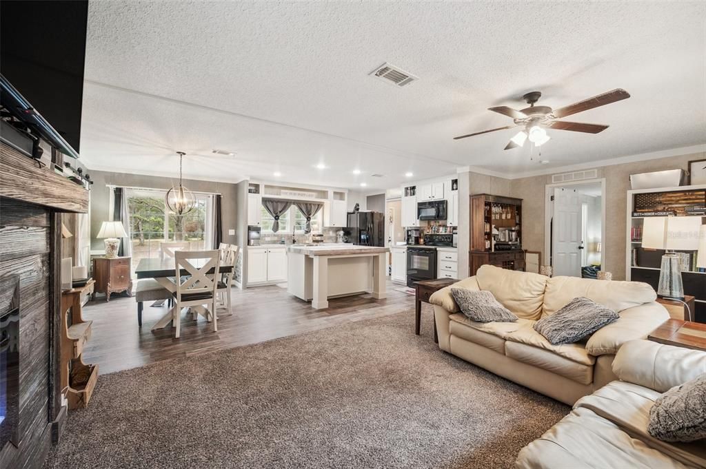 Dining room, Fireplace, Interior, Kitchen, Living room, Pendant Lights, Recessed Lighting, Stainless Steel Appliances, Wood Texture Flooring