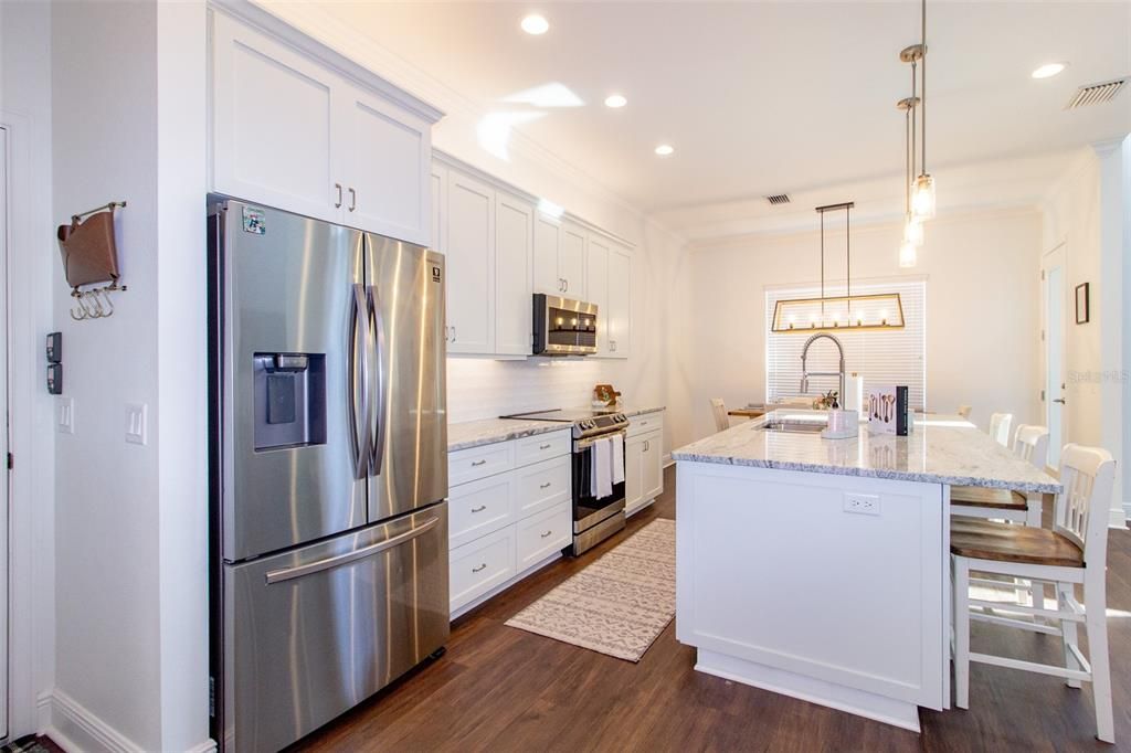 Dining room, Interior, Kitchen, Pendant Lights, Recessed Lighting, Stainless Steel Appliances, Wood Texture Flooring