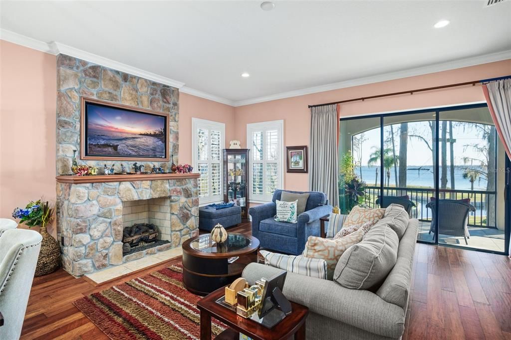 Fireplace, Interior, Living room, Recessed Lighting, Stone Walls, Water, Wood Texture Flooring
