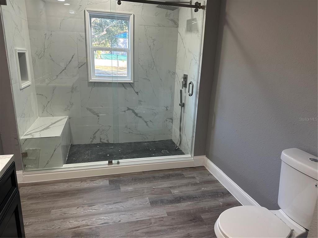 Bathroom, Glass Shower, Interior, Marble Walls, Wood Texture Flooring