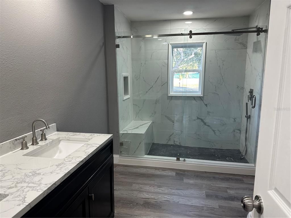 Bathroom, Glass Shower, Interior, Marble Walls, Recessed Lighting, Wood Texture Flooring