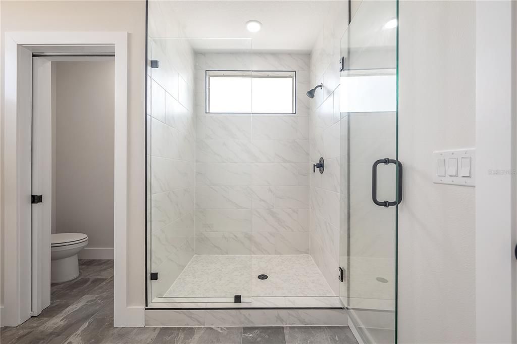 Bathroom, Glass Shower, Interior, Marble Walls, Wood Texture Flooring