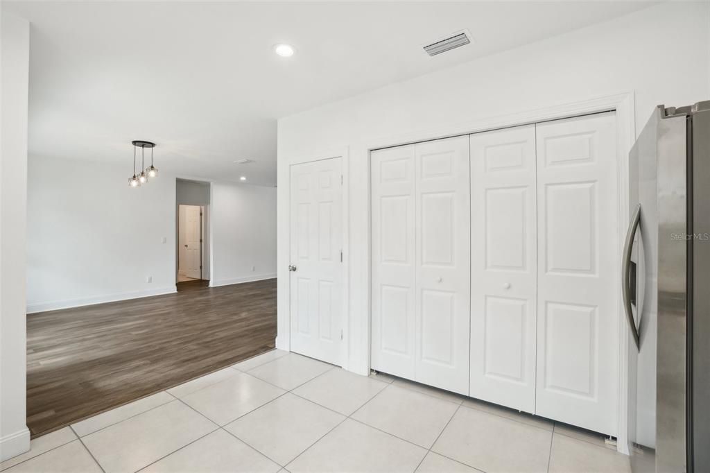 Empty room, Interior, Kitchen, Pendant Lights, Recessed Lighting, Stainless Steel Appliances, Wood Texture Flooring