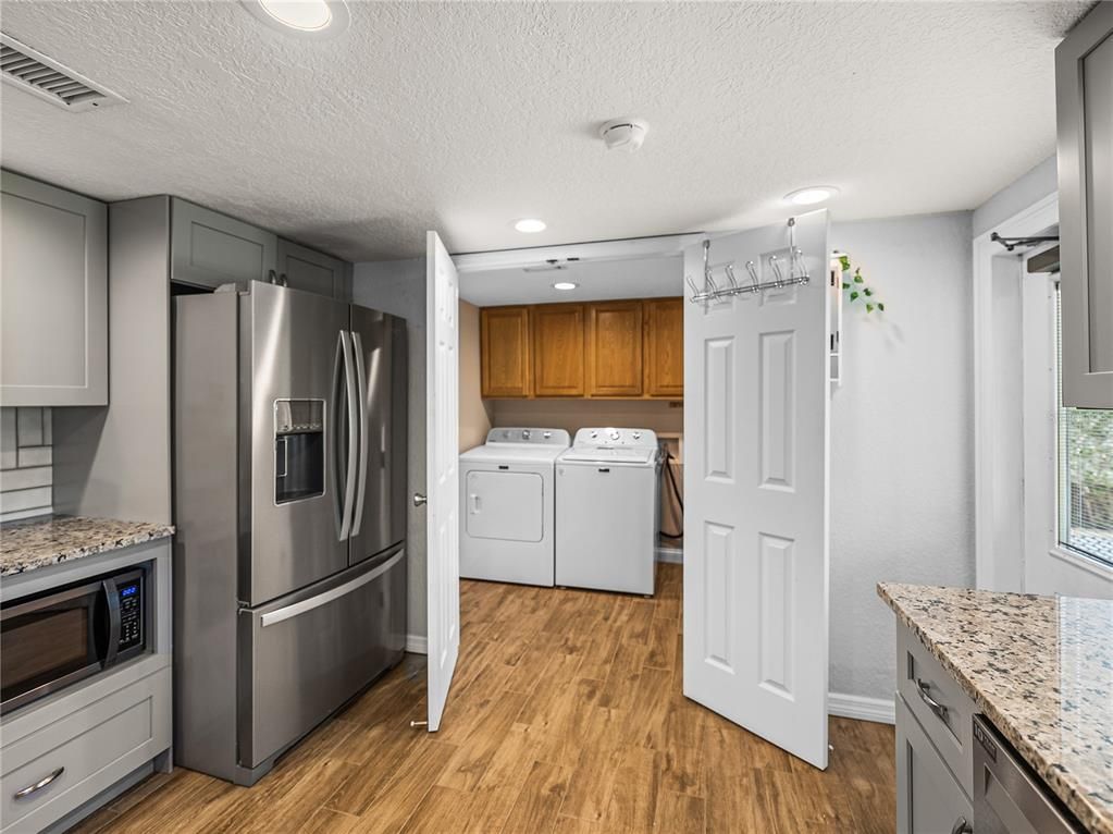Interior, Kitchen, Recessed Lighting, Washer, Wood Texture Flooring