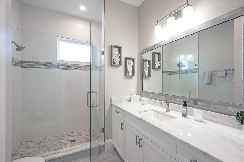 Bathroom, Dual Sink Vanities, Glass Shower, Interior, Recessed Lighting, Wood Texture Flooring