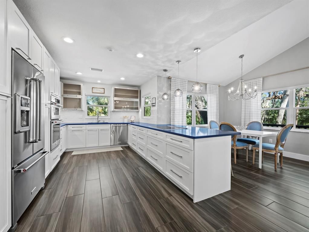 Chandelier, Dining room, Interior, Kitchen, Pendant Lights, Recessed Lighting, Stainless Steel Appliances, Wood Texture Flooring