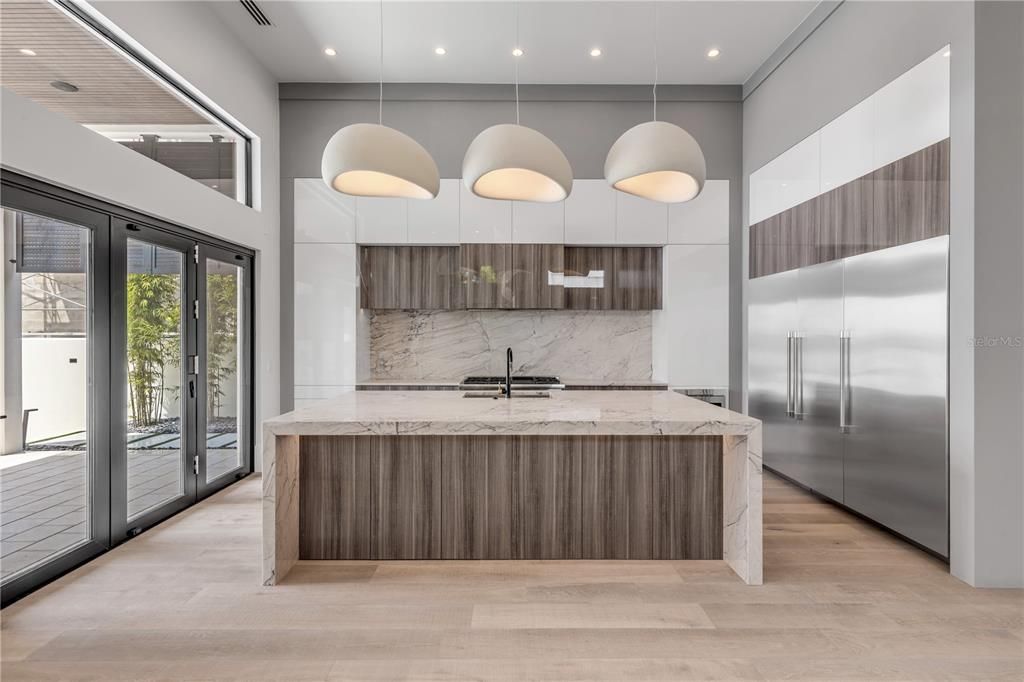 Interior, Kitchen, Marble Walls, Pendant Lights, Recessed Lighting, Stainless Steel Appliances, Wood Texture Flooring