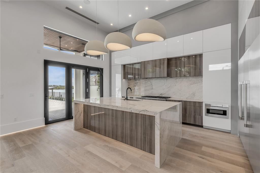 Interior, Kitchen, Marble Walls, Pendant Lights, Recessed Lighting, Stainless Steel Appliances, Wood Texture Flooring