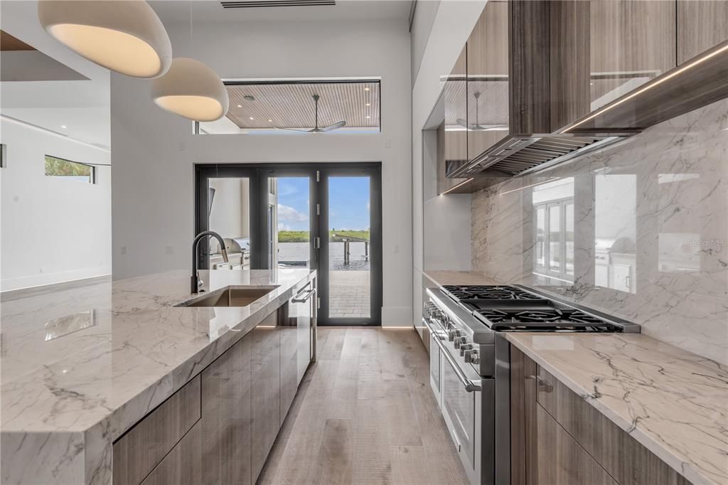 Interior, Kitchen, Marble Walls, Pendant Lights, Stainless Steel Appliances, Water, Wood Texture Flooring