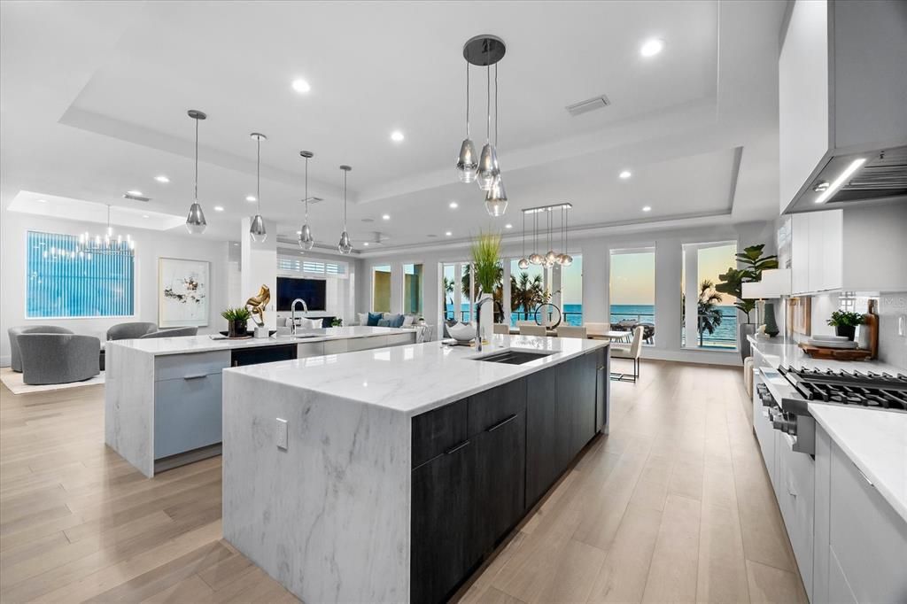 Chandelier, Dining room, Interior, Kitchen, Living room, Pendant Lights, Recessed Lighting, Stainless Steel Appliances, Water, Wood Texture Flooring