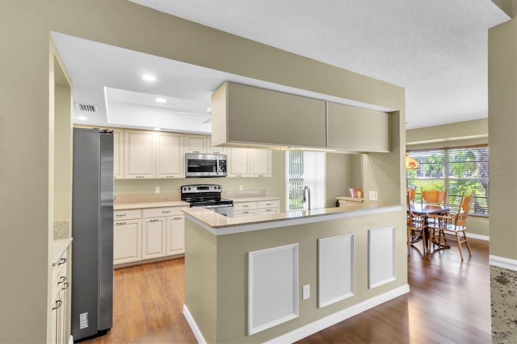 Dining room, Interior, Kitchen, Recessed Lighting, Stainless Steel Appliances, Wood Texture Flooring