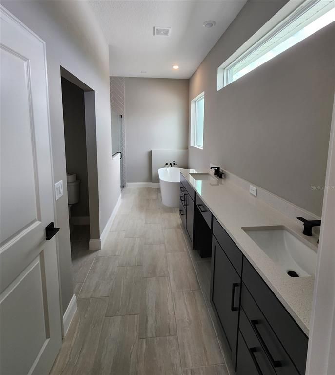 Bathroom, Dual Sink Vanities, Free Standing Baths, Interior, Recessed Lighting, Wood Texture Flooring