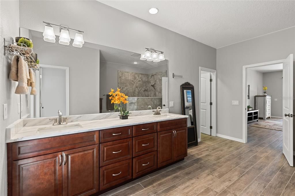 Bathroom, Dual Sink Vanities, Interior, Marble Walls, Recessed Lighting, Wood Texture Flooring