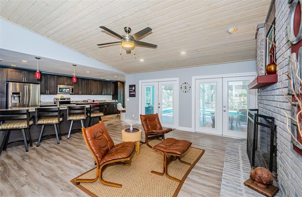 Fireplace, Interior, Kitchen, Pendant Lights, Recessed Lighting, Stainless Steel Appliances, Stone Walls, Wood Texture Flooring