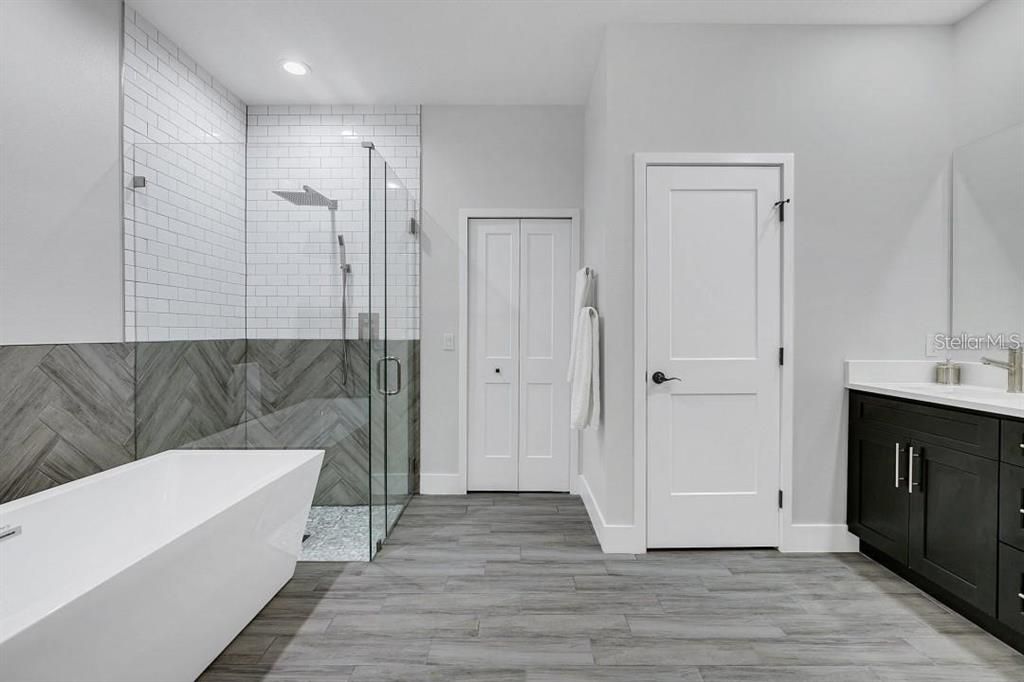 Bathroom, Free Standing Baths, Glass Shower, Interior, Recessed Lighting, Wood Texture Flooring