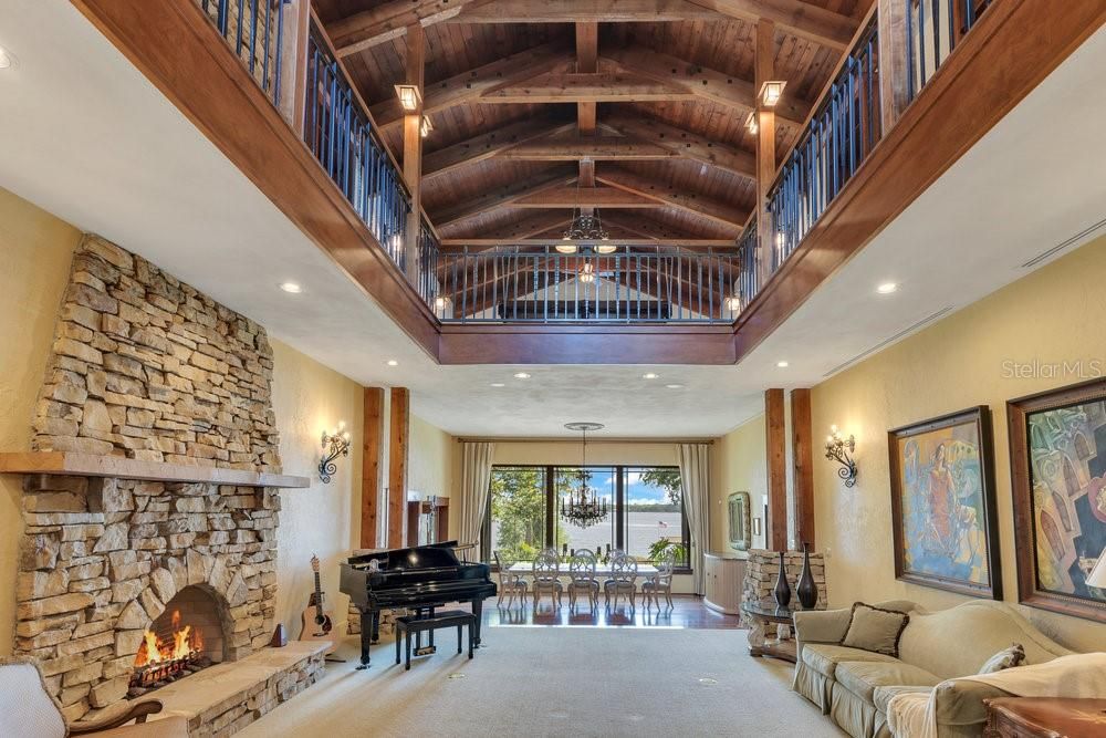 Chandelier, Dining room, Fireplace, Interior, Living room, Piano, Recessed Lighting, Stone Walls, Wooden Beams, Wooden Ceilings