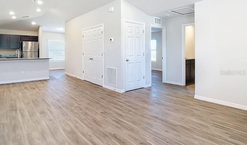 Empty room, Interior, Kitchen, Recessed Lighting, Stainless Steel Appliances, Wood Texture Flooring
