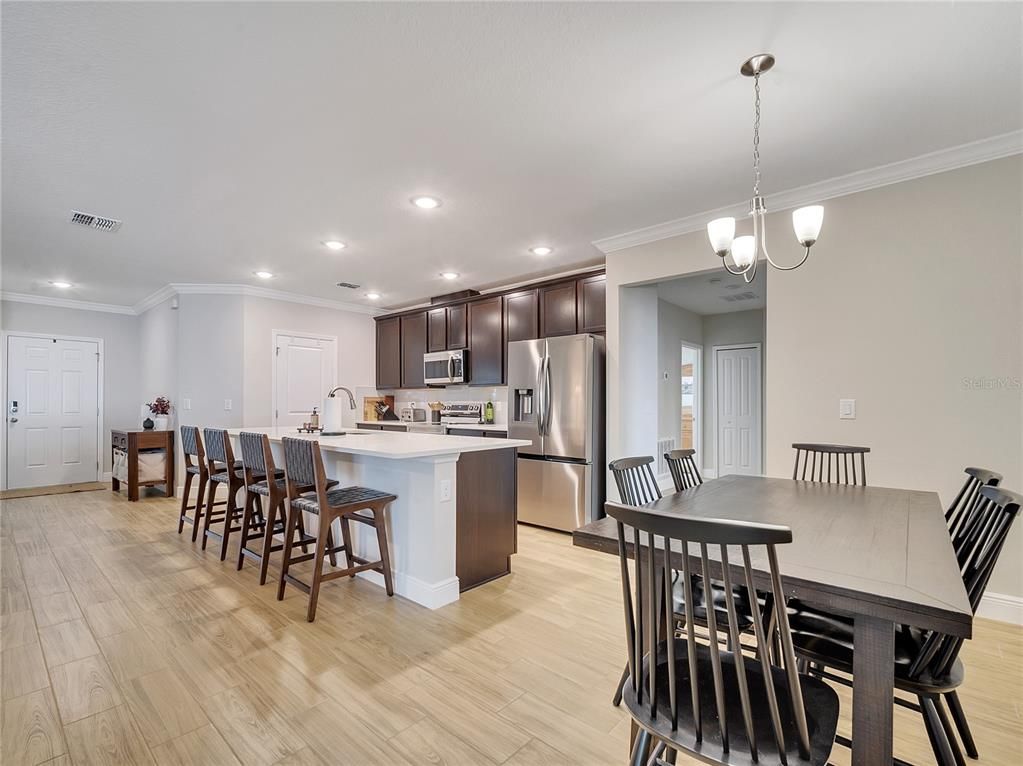 Chandelier, Dining room, Interior, Kitchen, Pendant Lights, Recessed Lighting, Stainless Steel Appliances, Wood Texture Flooring