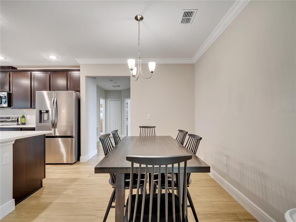 Chandelier, Dining room, Interior, Kitchen, Pendant Lights, Recessed Lighting, Stainless Steel Appliances, Wood Texture Flooring