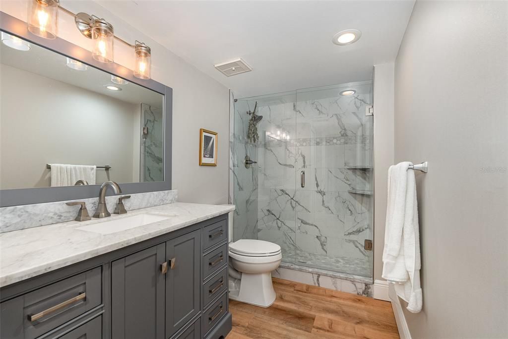 Bathroom, Glass Shower, Interior, Marble Walls, Recessed Lighting, Wood Texture Flooring