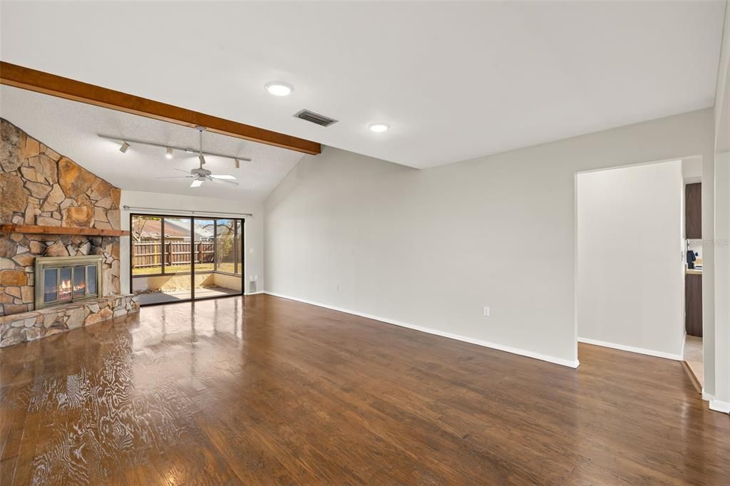 Empty room, Fireplace, Interior, Recessed Lighting, Stone Walls, Wooden Beams, Wood Texture Flooring