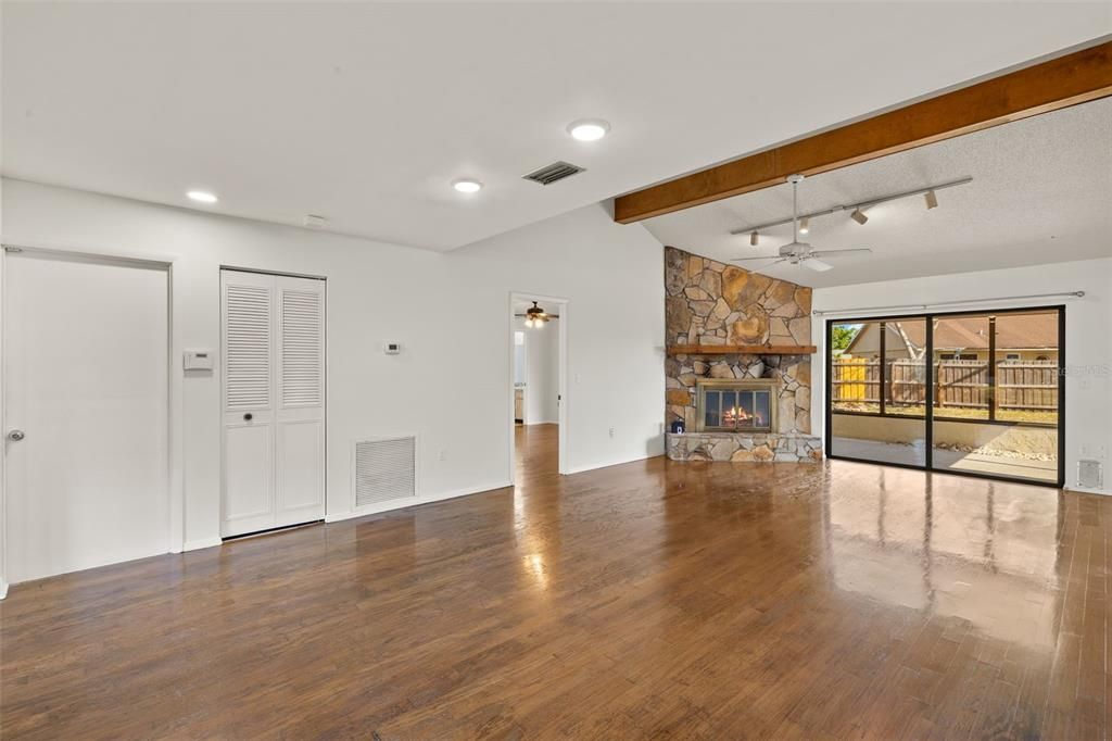Empty room, Fireplace, Interior, Recessed Lighting, Wooden Beams, Wood Texture Flooring