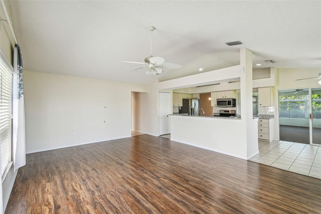 Empty room, Interior, Kitchen, Recessed Lighting, Stainless Steel Appliances, Wood Texture Flooring