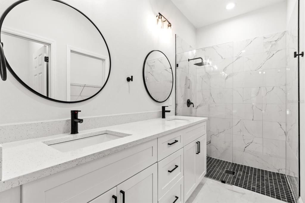 Bathroom, Dual Sink Vanities, Glass Shower, Interior, Marble Walls, Recessed Lighting